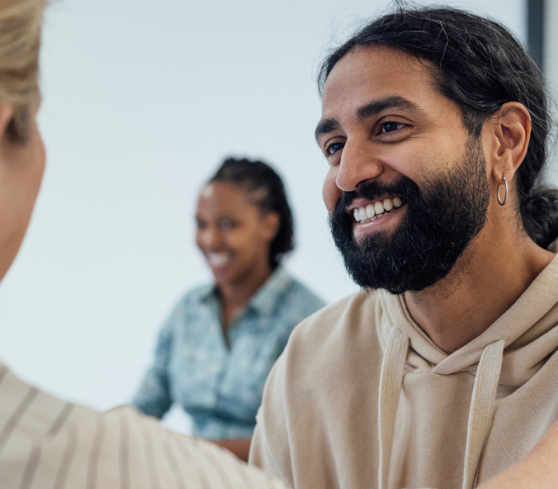 young male looking happy receiving good news at the hospital